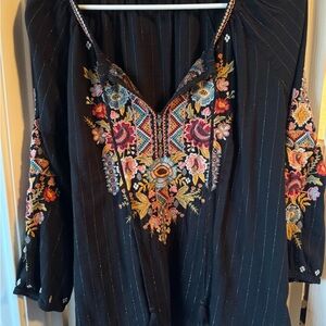 Johnny was  Clothing Black Top with gold trim